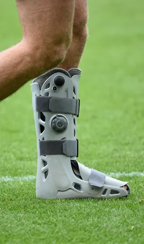 Injured player wearing a medical boot
